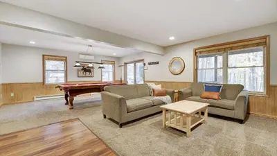 a living room with couches and a pool table at Woodland Oasis by AvantStay Hot Tub Firepit Walk to Lake in Lake Harmony
