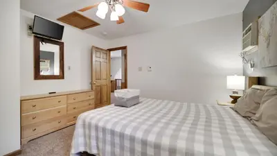 a bedroom with a bed with a box on it at Woodland Oasis by AvantStay Hot Tub Firepit Walk to Lake in Lake Harmony