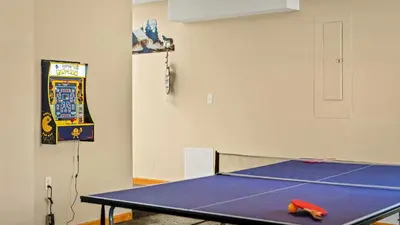 a ping pong table in a room with a ping pong racket at The Nest at Brier Crest by AvantStay Game Room Expansive Deck Fire Pit in Blakeslee