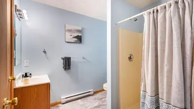 a bathroom with a shower curtain and a sink at The Nest at Brier Crest by AvantStay Game Room Expansive Deck Fire Pit in Blakeslee