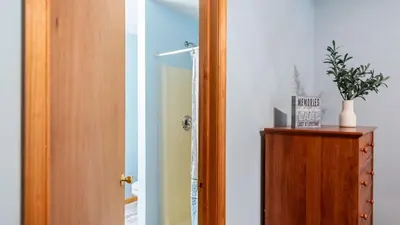 a hallway with a door and a plant on a cabinet at The Nest at Brier Crest by AvantStay Game Room Expansive Deck Fire Pit in Blakeslee
