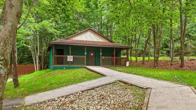 a small building in the middle of a forest at The Nest at Brier Crest by AvantStay Game Room Expansive Deck Fire Pit in Blakeslee