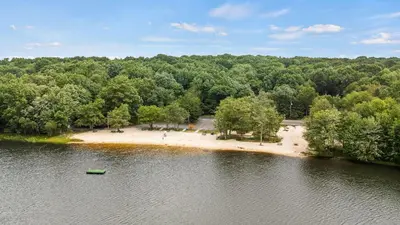 an aerial view of an island in the middle of a lake at The Nest at Brier Crest by AvantStay Game Room Expansive Deck Fire Pit in Blakeslee