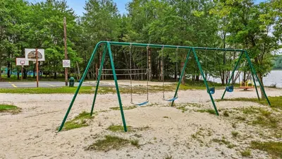 a swing set in the sand in a park at 7mins to Skiing Fire Pit Game Table Lake Access Hygge Home by AvantStay in Blakeslee