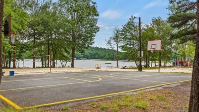 a basketball court with a basketball hoop on a lake at 7mins to Skiing Fire Pit Game Table Lake Access Hygge Home by AvantStay in Blakeslee
