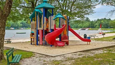 a playground with a slide in a park at 7mins to Skiing Fire Pit Game Table Lake Access Hygge Home by AvantStay in Blakeslee