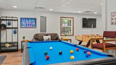 a living room with a pool table in it at Maple Oasis by AvantStay Newly Built w Hot Tub Game Room Fire Pit in Blakeslee