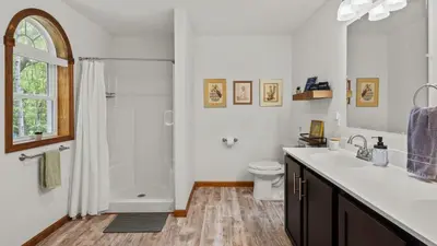 a white bathroom with a sink and a shower at Maple Oasis by AvantStay Newly Built w Hot Tub Game Room Fire Pit in Blakeslee