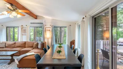 a living room with a couch and a table at Lakeshore Oasis by AvantStay Private Beach Views Hot Tub Volleyball in Blakeslee