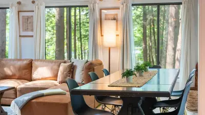 a living room with a couch and a table at Lakeshore Oasis by AvantStay Private Beach Views Hot Tub Volleyball in Blakeslee