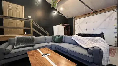 a living room with a couch and a table at Lakeshore Oasis by AvantStay Private Beach Views Hot Tub Volleyball in Blakeslee