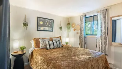 a bedroom with a large bed and a window at Lakeshore Oasis by AvantStay Private Beach Views Hot Tub Volleyball in Blakeslee
