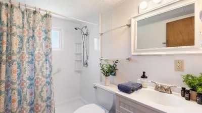 a bathroom with a sink and a toilet and a shower at The Lake Life by AvantStay Lakefront View Hot Tub in Arrowhead Lake