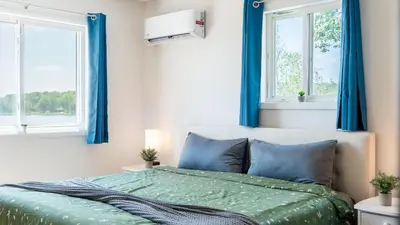 a bedroom with blue curtains and a bed at The Lake Life by AvantStay Lakefront View Hot Tub in Arrowhead Lake