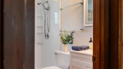 a bathroom with a shower and a toilet and a sink at The Lake Life by AvantStay Lakefront View Hot Tub in Arrowhead Lake