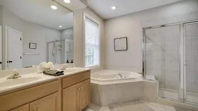 a bathroom with a tub and a sink and a shower at The Nest at Pinecrest by AvantStay Spacious Deck Game Room Fire Pit in Pocono Pines