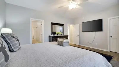 a bedroom with a large bed with a flat screen tv at The Nest at Pinecrest by AvantStay Spacious Deck Game Room Fire Pit in Pocono Pines