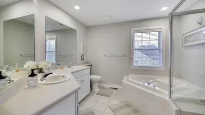 a bathroom with a sink and a tub and a toilet at The Nest at Pinecrest by AvantStay Spacious Deck Game Room Fire Pit in Pocono Pines