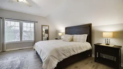 a bedroom with a large bed and a window at The Nest at Pinecrest by AvantStay Spacious Deck Game Room Fire Pit in Pocono Pines