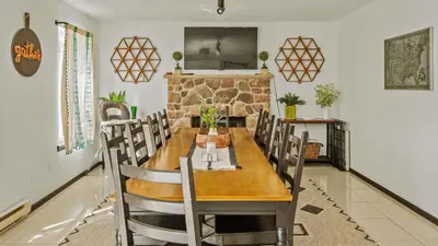 a dining room with a wooden table and chairs at Mountain Mindset by AvantStay Pool Hot Tub Game Room Firepit in Long Pond