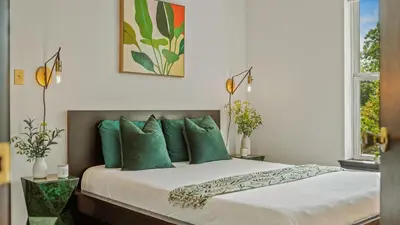 a bedroom with a large bed with green pillows at Mountain Mindset by AvantStay Pool Hot Tub Game Room Firepit in Long Pond