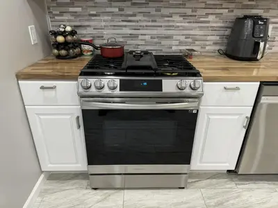 a kitchen with a stove with a pot on it at Modern Queen Room Near EWR in Elizabeth