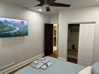 a bedroom with a bed with two towels on it at Modern Queen Room Near EWR in Elizabeth