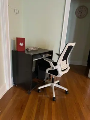 a desk with a white chair and a computer monitor at Modern Queen Room Near EWR in Elizabeth