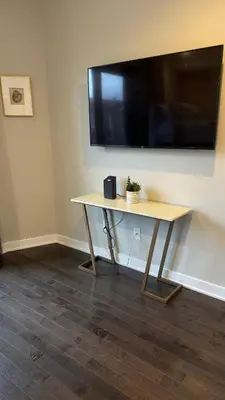 a wooden table with a large television on a wall at Hot Tub Four Seasons in Philadelphia