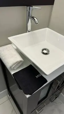a white sink in a bathroom with a black towel at Hot Tub Four Seasons in Philadelphia