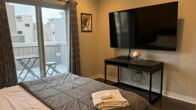 a bedroom with a large flat screen tv on the wall at Hot Tub Four Seasons in Philadelphia