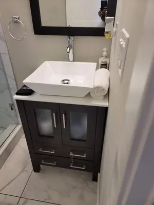 a bathroom with a white sink and a mirror at Hot Tub Four Seasons in Philadelphia