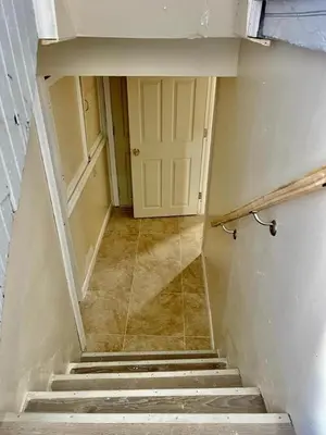 an empty hallway with a door and stairs in a room at Z & Z Apartment 2 in Newark