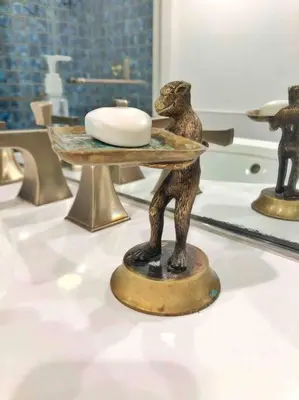 a statue of a monkey with a plate on a table at Center City Townhome in Quiet Courtyard in Philadelphia