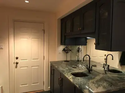 a kitchen with two sinks and a white door at Center City Townhome in Quiet Courtyard in Philadelphia