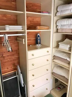 a closet with white drawers and a sink and towels at Center City Townhome in Quiet Courtyard in Philadelphia