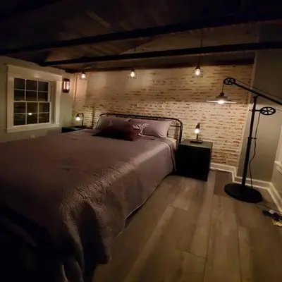a bedroom with a bed and a brick wall at Fun Fishtown Rowhome - Sleeps 4 in Philadelphia