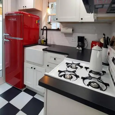 a kitchen with a stove and a red refrigerator at Fun Fishtown Rowhome - Sleeps 4 in Philadelphia