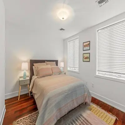 a bedroom with a bed and two windows at Bright & Modern Home with Patio in Philadelphia