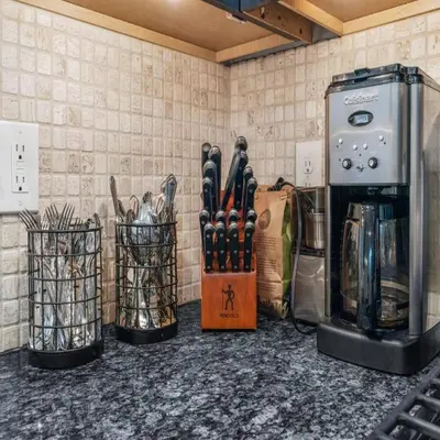 a kitchen counter with a bunch of utensils at Bright & Modern Home with Patio in Philadelphia