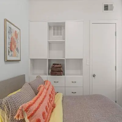 a bedroom with a bed and a white cabinet at Bright & Modern Home with Patio in Philadelphia