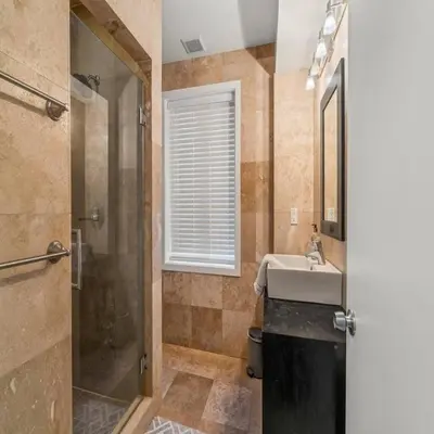 a bathroom with a shower and a sink and a shower at Bright & Modern Home with Patio in Philadelphia