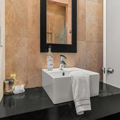 a bathroom with a white sink and a mirror at Bright & Modern Home with Patio in Philadelphia