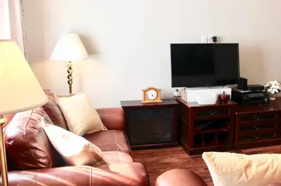 a living room with a couch and a flat screen tv at Walk to South Philly's Best Restaurants & Bars in Philadelphia