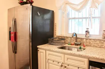 a kitchen with a stainless steel refrigerator and a sink at Walk to South Philly's Best Restaurants & Bars in Philadelphia