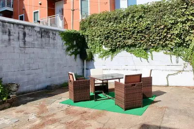 a table and two chairs on a green rug next to a wall at Walk to South Philly's Best Restaurants & Bars in Philadelphia