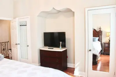 a bedroom with a tv on a dresser and a bed at Walk to South Philly's Best Restaurants & Bars in Philadelphia