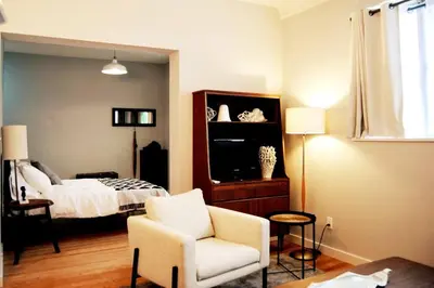 a living room with a bed and a chair at Trendy Studio in Prime South Philly Neighborhood in Philadelphia