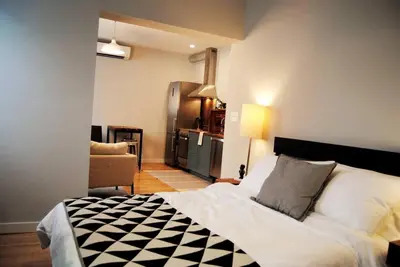 a bedroom with a bed with a black and white checkered blanket at Trendy Studio in Prime South Philly Neighborhood in Philadelphia