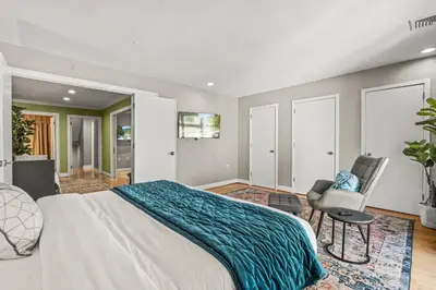 a bedroom with a large bed and a chair at 5 bdrm - Heated Indoor Pool - Elevator in Philadelphia